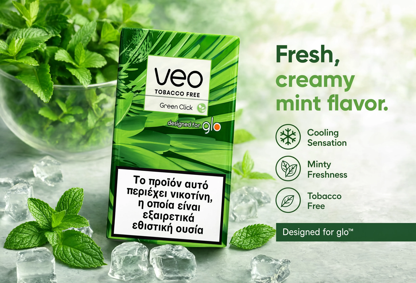Veo Tobacco Free Green Click menthol pouch packaging standing on a light stone surface with mint leaves, ice cubes, and a glass bowl of mint in the background. Text on the right describes the flavor as fresh, creamy mint, with cooling sensation, minty freshness, and tobacco free.