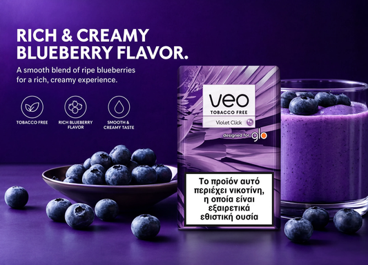 A package of VEO Tobacco Free Violet Click blueberry flavor rolling paper stands next to a glass of purple blueberry smoothie on a dark purple background, with blueberries scattered around and descriptive text on the left.
