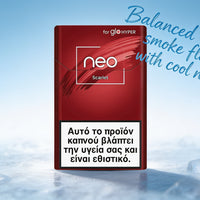 A pack of glo HYPER neo Scarlet cigarettes stands upright on a snowy surface against a light blue sky background. The pack is deep red with white branding and a large health warning label on the lower half.