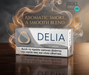 Delia Classic Silver IQOS device packaging with aromatic smoke and leaves on a reflective surface.