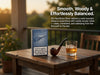 A pack of Glo NeoSticks Silver tobacco pods stands on a rustic wooden table beside a smoking pipe and a glass of amber liquid, with outdoor patio furniture and warm sunset light in the background. White promotional text appears on the right side.