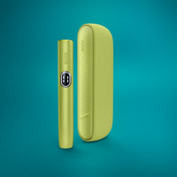 The image shows two views of the IQOS ILUMA i Kit in Leaf Green, one of the device itself and one of its case.