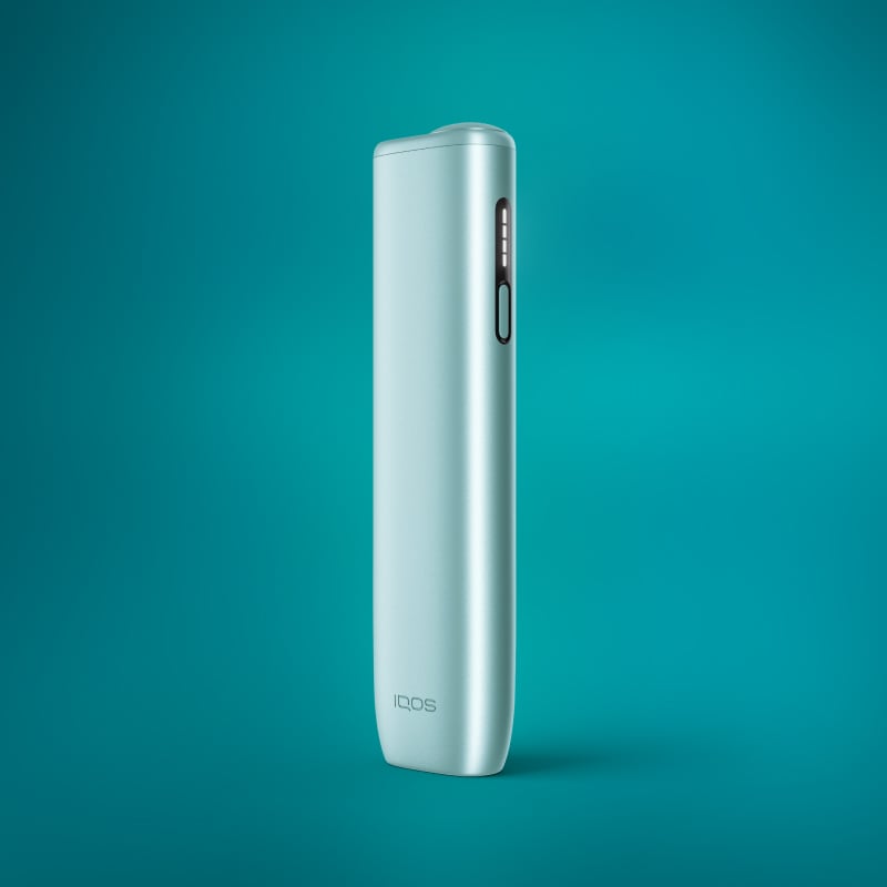 A slim, cylindrical IQOS ILUMA i One Kit in Breeze Blue color against a blue background.