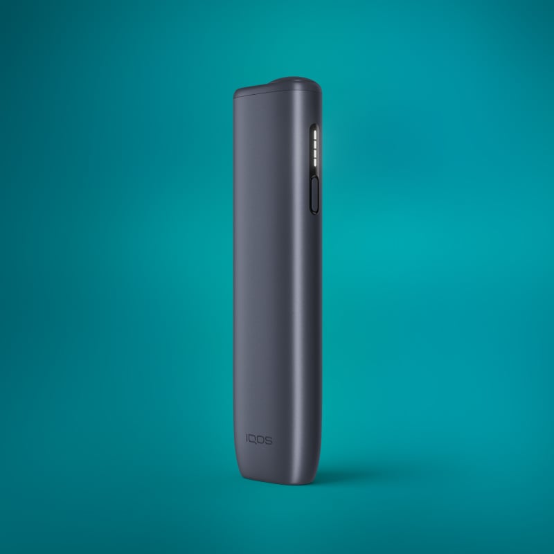 A sleek, compact IQOS ILUMA i One device in Midnight Black color against a teal background.