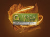 A pack of Terea Soft Fuse for Iodis Isuma tobacco smokeless product, shown in a green and white box with a warning label, surrounded by golden glowing leaves on a dark brown background.
