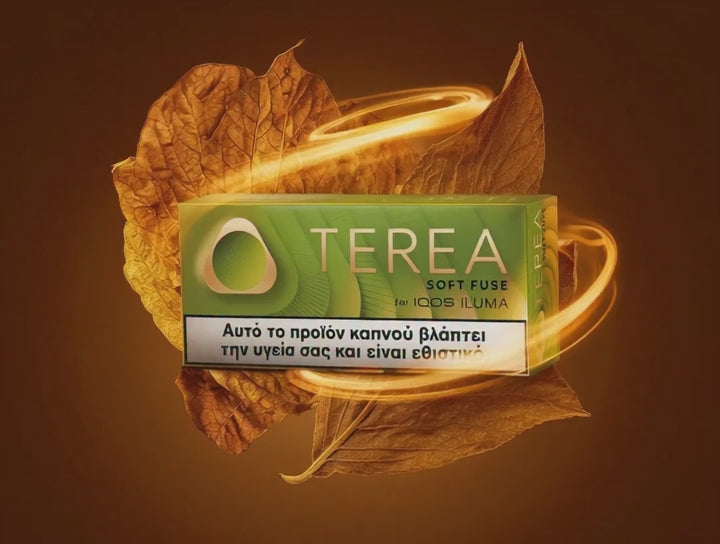 A pack of Terea Soft Fuse for Iodis Isuma tobacco smokeless product, shown in a green and white box with a warning label, surrounded by golden glowing leaves on a dark brown background.