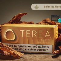 A box of TERA Yellow 4000 ILUMA tobacco product sits on a wooden surface surrounded by dried brown tobacco leaves. The box is golden yellow with the brand name 'TEREA' in large white letters and a health warning band at the bottom.