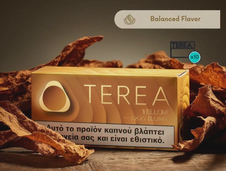 A box of TERA Yellow 4000 ILUMA tobacco product sits on a wooden surface surrounded by dried brown tobacco leaves. The box is golden yellow with the brand name 'TEREA' in large white letters and a health warning band at the bottom.
